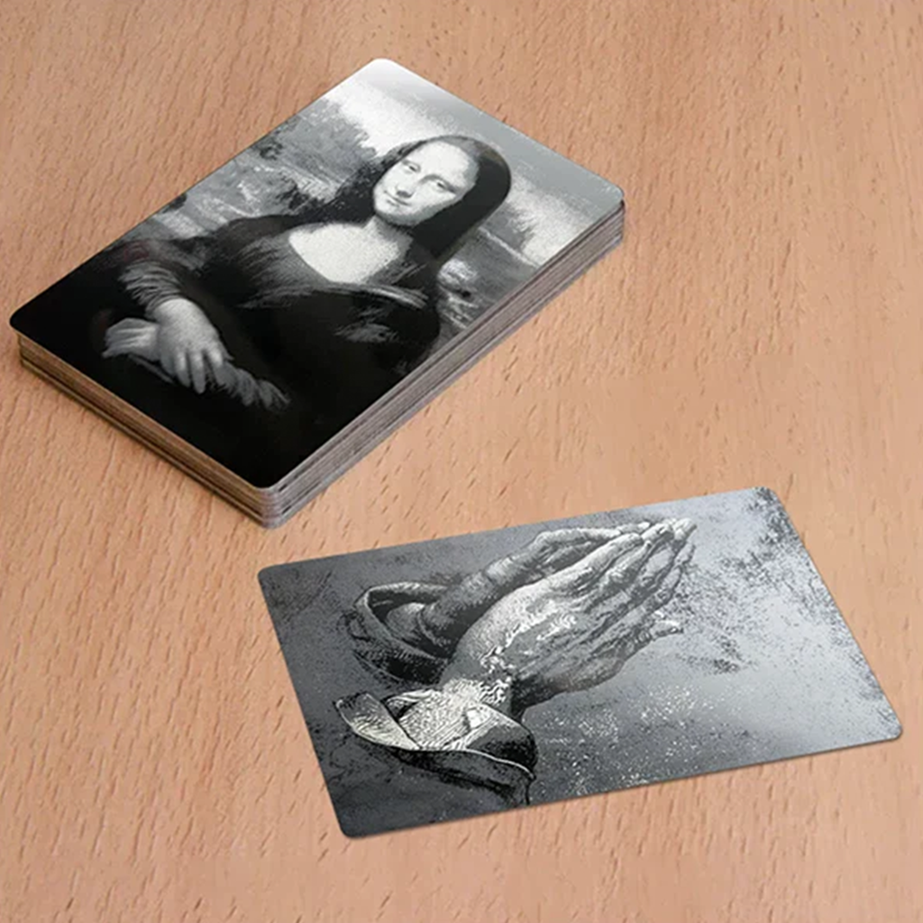 Set of 10 laser-engraved metal business cards by Kombis, showcasing sleek design and detailed craftsmanship.
