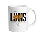 Kombis "Lūsis" mug featuring a playful illustration of a moose in a cozy woodland scene.